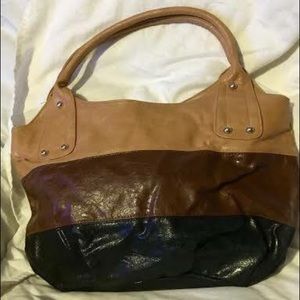 Medium to large brown and tan handbag.